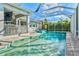 Outdoor pool and spa area with a screened-in patio and lush landscaping offering privacy at 556 Regatta Way, Bradenton, FL 34208