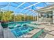 Relaxing pool and spa combo with stepping stones, enclosed in a screened-in lanai at 556 Regatta Way, Bradenton, FL 34208