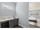 Convenient wet bar with a wine refrigerator, sink, and cabinetry located off the main bedroom at 556 Regatta Way, Bradenton, FL 34208