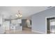 Open-concept living room with tile flooring, light gray walls, and a view into the kitchen at 5609 Modena Pl, Sarasota, FL 34238