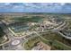 Wide aerial shot of community showcasing tennis courts, pool, golf course, clubhouse, and manicured landscaping at 5694 Palmer Cir # 204, Lakewood Ranch, FL 34211