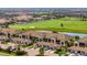 Beautiful aerial view of luxury condominiums overlooking a lush golf course and serene lake at 5694 Palmer Cir # 204, Lakewood Ranch, FL 34211