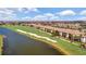 Scenic aerial view showcases a golf course community with homes bordering a pristine green at 5694 Palmer Cir # 204, Lakewood Ranch, FL 34211