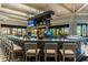 Stylish bar area with comfortable seating, modern lighting, and multiple screens for entertainment at 5694 Palmer Cir # 204, Lakewood Ranch, FL 34211