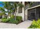 Close up of entrance with landscaping, staircase, and secure screen door with a small railing at 5694 Palmer Cir # 204, Lakewood Ranch, FL 34211