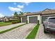 Well-maintained building featuring multiple garages, complemented by a neatly paved driveway and manicured landscaping at 5694 Palmer Cir # 204, Lakewood Ranch, FL 34211