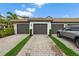 A well-maintained building featuring multiple garages, complemented by a neatly paved driveway and manicured landscaping at 5694 Palmer Cir # 204, Lakewood Ranch, FL 34211