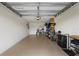Spacious garage with overhead door, ample storage on shelves, and room for parking and organizing at 5694 Palmer Cir # 204, Lakewood Ranch, FL 34211