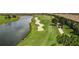 Picturesque golf course view, featuring a pristine lake, lush green, and well-maintained sand traps at 5694 Palmer Cir # 204, Lakewood Ranch, FL 34211