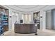 Upscale reception area with a curved desk, elegant decor, and soft lighting, creating a welcoming atmosphere at 5694 Palmer Cir # 204, Lakewood Ranch, FL 34211