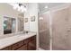 This bathroom offers a sleek walk-in shower with glass doors and a vanity with granite countertops at 5694 Palmer Cir # 204, Lakewood Ranch, FL 34211