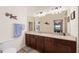 This updated bathroom boasts a double vanity with granite countertops, plenty of cabinet space, and stylish fixtures at 5694 Palmer Cir # 204, Lakewood Ranch, FL 34211
