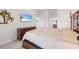 This spacious bedroom features modern decor, a large bed, and a flat-screen TV for ultimate relaxation at 5694 Palmer Cir # 204, Lakewood Ranch, FL 34211