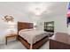 Relaxing primary bedroom with a decorative headboard, cozy bedding, and a window at 5694 Palmer Cir # 204, Lakewood Ranch, FL 34211