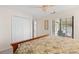 Relaxing bedroom with a large closet, a window with natural light, and a view to an outdoor patio at 5694 Palmer Cir # 204, Lakewood Ranch, FL 34211