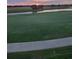 Scenic view of a lush golf course with a serene pond and a paved pathway at 5694 Palmer Cir # 204, Lakewood Ranch, FL 34211