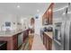 This kitchen features granite countertops, stainless appliances and a view into the adjacent dining and living rooms at 5694 Palmer Cir # 204, Lakewood Ranch, FL 34211
