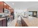 Spacious kitchen with stainless steel appliances, granite countertops, and a breakfast bar that seats three at 5694 Palmer Cir # 204, Lakewood Ranch, FL 34211