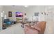 This cozy living room is elegantly furnished with a neutral color palette and a large screen TV at 5694 Palmer Cir # 204, Lakewood Ranch, FL 34211