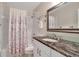 Well-lit bathroom with granite countertop, shower/tub combo and modern fixtures at 5808 18Th W St # A & B, Bradenton, FL 34207