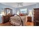 Cozy bedroom with blue walls, hardwood floors, and a decorative metal bed frame at 5808 18Th W St # A & B, Bradenton, FL 34207