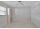 Bright bedroom with a ceiling fan, window with blinds, closet, and a built-in bookshelf against the wall at 5808 18Th W St # A & B, Bradenton, FL 34207