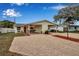 Attractive single-story home with brick driveway, yellow siding, and a covered carport area at 5808 18Th W St # A & B, Bradenton, FL 34207