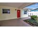 Charming front porch featuring a bright red door, manicured landscaping and shade at 5808 18Th W St # A & B, Bradenton, FL 34207