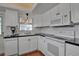 Efficient kitchen with white cabinets, black countertops, and modern appliances at 5808 18Th W St # A & B, Bradenton, FL 34207