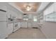 All-white kitchen features stainless steel appliances, a window, and an exterior door at 5808 18Th W St # A & B, Bradenton, FL 34207