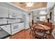 Kitchen with white cabinetry, black countertops, dining area, and open access to the living room at 5808 18Th W St # A & B, Bradenton, FL 34207