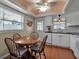 Cozy kitchen featuring a dining area with wooden table and chairs, natural lighting, and white cabinetry at 5808 18Th W St # A & B, Bradenton, FL 34207
