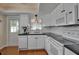 White kitchen with black countertops, tiled backsplash, and modern appliances at 5808 18Th W St # A & B, Bradenton, FL 34207