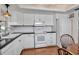 Charming kitchen featuring white cabinets, black countertops, and wood flooring at 5808 18Th W St # A & B, Bradenton, FL 34207
