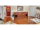 Living room featuring hardwood floors, built-in wooden cabinet, and comfortable ottoman at 5808 18Th W St # A & B, Bradenton, FL 34207