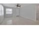 Bright living room featuring a window with sheer curtains, neutral paint and tile flooring at 5808 18Th W St # A & B, Bradenton, FL 34207