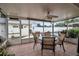 Relaxing screened-in patio with tiled floor, ceiling fan, and view of fenced backyard with pool at 5808 18Th W St # A & B, Bradenton, FL 34207