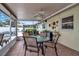 Relaxing screened-in patio with tiled floor, ceiling fan, and view of fenced backyard with pool at 5808 18Th W St # A & B, Bradenton, FL 34207