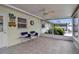 This enclosed patio features tile floors, a ceiling fan, and sliding glass windows to view the backyard at 5808 18Th W St # A & B, Bradenton, FL 34207