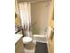 Cozy bathroom featuring a tub with shower, safety bar, neutral tile, and charming floral shower curtain at 6012 Oak Creek Ln # 1913, Bradenton, FL 34210