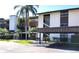 Exterior view of Timber Creek condo complex featuring covered parking and lush landscaping at 6012 Oak Creek Ln # 1913, Bradenton, FL 34210