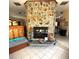Stone fireplace is a stunning focal point with a tiled hearth and charming rustic decor at 6012 Oak Creek Ln # 1913, Bradenton, FL 34210