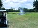 Picturesque view of the Timber Creek golf course featuring a water feature and mature trees at 6012 Oak Creek Ln # 1913, Bradenton, FL 34210