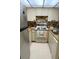 Compact kitchen includes oven, stovetop, refrigerator and cabinets providing ample storage and workspace at 6012 Oak Creek Ln # 1913, Bradenton, FL 34210