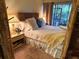 Comfortable main bedroom featuring a queen-sized bed, a bedside table and access to the porch at 6012 Oak Creek Ln # 1913, Bradenton, FL 34210