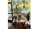 Enclosed porch filled with a variety of potted plants and decor, creating a cozy outdoor space at 6012 Oak Creek Ln # 1913, Bradenton, FL 34210