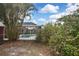 View of screened-in pool from backyard with lush landscaping at 6023 Mayberry Ave, North Port, FL 34287