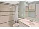 Bathroom with white tiled shower, vanity with sink, and medicine cabinet at 6023 Mayberry Ave, North Port, FL 34287