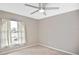 Bedroom featuring neutral walls, carpeting, a window, and a ceiling fan at 6023 Mayberry Ave, North Port, FL 34287