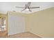 Bedroom featuring carpeting, neutral walls, ceiling fan, and a closet at 6023 Mayberry Ave, North Port, FL 34287